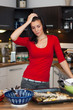 Foto: Unhappy woman standing in kitchen Unhappy woman standing in kitchen