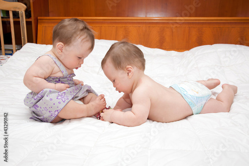Photo: Two baby twins playing together Two baby twins playing together
