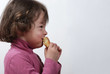 Foto: A young girl eating a bun A young girl eating a bun