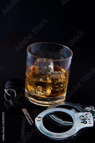 Photo: Whiskey on the rocks with car key and handcuff Whiskey on the rocks with car key and handcuff