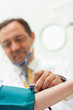 Doctor placing his stethoscope on the arm of his patient