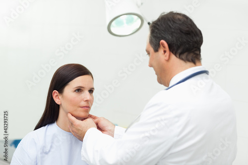 Photo: Doctor auscultating the neck of his patient Doctor auscultating the neck of his patient