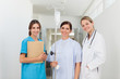 Doctor standing in a hallway with a patient and a nurse