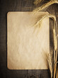 wheat on the old wooden table and old paper
