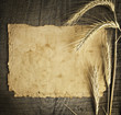 wheat on the old wooden table and old paper