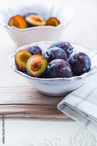 Photo: Fresh plums on a kitchen table Fresh plums on a kitchen table