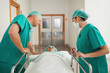 Surgeons leaning on a medical bed