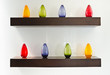 Photo: Colorful glass bottles on wooden shelf Colorful glass bottles on wooden shelf