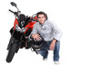 Man crouching next to motorcycle