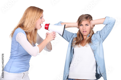 Photo: Girls screaming in a bullhorn and girl covering her ears Girls screaming in a bullhorn and girl covering her ears