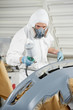auto mechanic painting car bumper