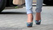 female legs in trousers on a high heel