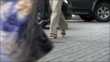 Street scene. Going feet of the woman in trousers