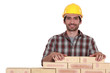 Man building brick wall
