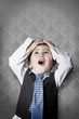 Foto: child dressed like businessman with hands on head and face of su child dressed like businessman with hands on head and face of su