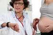 Doctor in appointment with pregnant woman