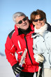 Older ski couple on a mountain