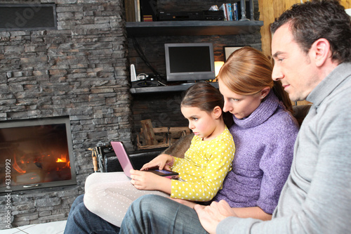 Photo: Family on a sofa in front of the fireplace Family on a sofa in front of the fireplace