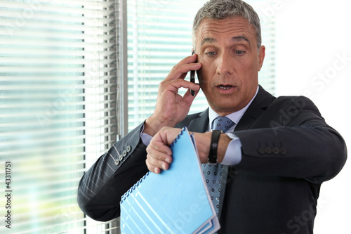 Photo: Businessman realizing he is late Businessman realizing he is late
