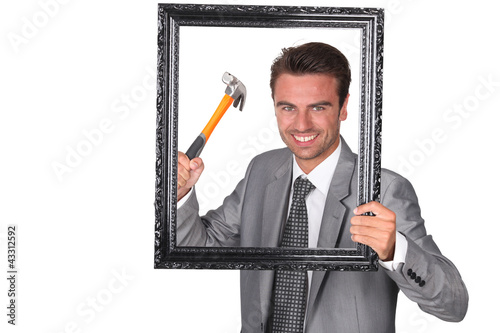 Photo: Agressive businessman with picture frame Agressive businessman with picture frame