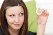 young woman with a condom (view to condom)