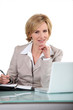 Blond office worker sat at desk