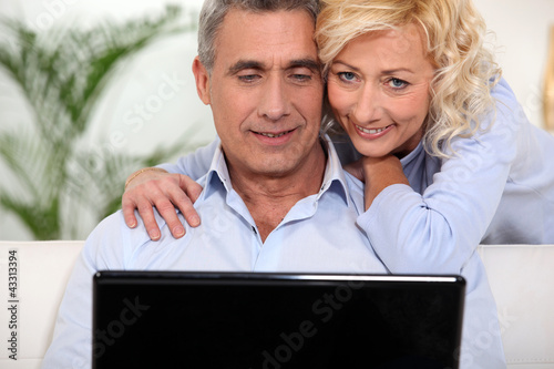 Photo: Married couple surfing the Internet together Married couple surfing the Internet together