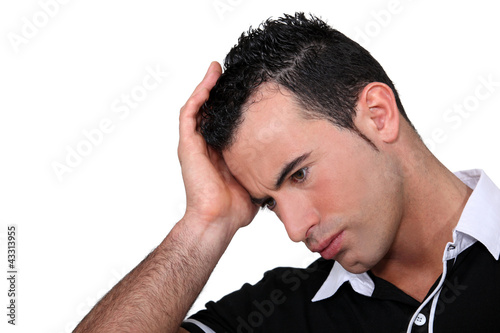 Photo: A casual man with a headache. A casual man with a headache.