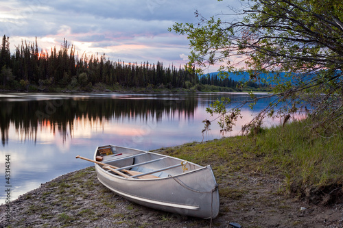 Photo: Sunset sky and canoe at Teslin River Yukon Canada Sunset sky and canoe at Teslin River Yukon Canada