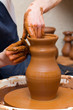 potter makes a jug out of clay