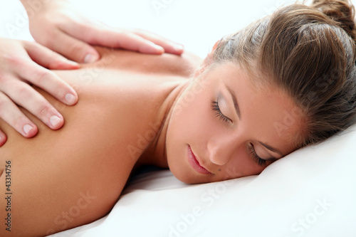 Foto: Woman enjoying a massage therapy Woman enjoying a massage therapy