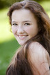 Portrait of young smiling girl in the park