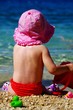 Summer time - child play on the  pebbles beach