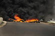 Burning tires during a protest causing poisoning smoke