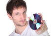 Young man showing CD, studio shot