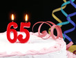 Birthday cake with red candles showing Nr. 65