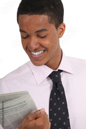 Photo: Young man reading a newspaper Young man reading a newspaper