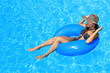 Young woman enjoying a swimming pool