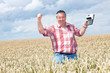 Farmer with computing machine in the field
