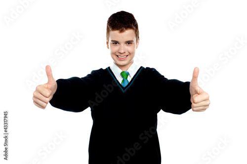 Photo: Cute kid showing double thumbs up to camera Cute kid showing double thumbs up to camera