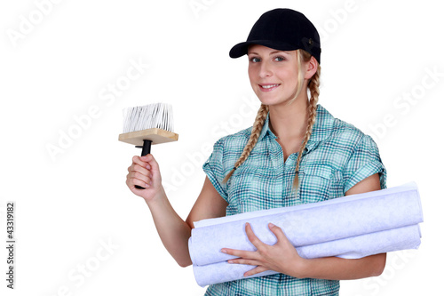 Photo: Woman putting up wallpaper Woman putting up wallpaper