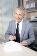 happy businessman sign a contract