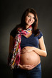 Photo: Pregnant woman over dark background Pregnant woman over dark background