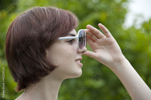 Photo: young girl with white sunglasses young girl with white sunglasses