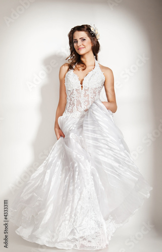 Photo: Portrait of beautiful young bride on white Portrait of beautiful young bride on white