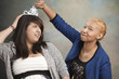 Woman putting tiara on friend's head