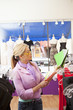 Hispanic business owner choosing decorating colors in store