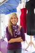 Smiling Hispanic business owner standing in store