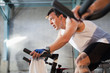 Hispanic man on exercise bikes in health club