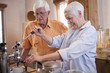 Caucasian couple making coffee in kitchen